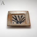 Square glazed stoneware plate with a grass motif